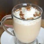 Copycat Starbucks maple pecan latte with whipped cream and chopped pecans on top.