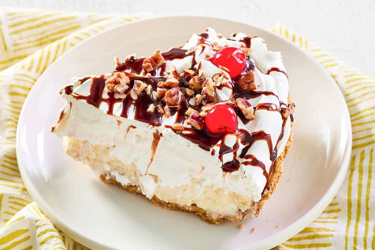 Banana pineapple pie with whipped cream and toppings.
