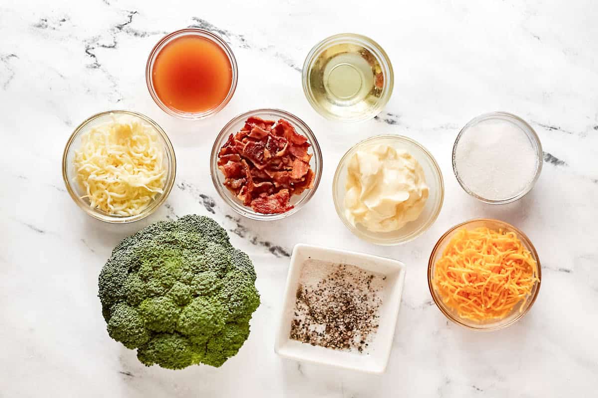 Broccoli, cheeses, bacon, mayonnaise, vinegar, oil, and seasonings.