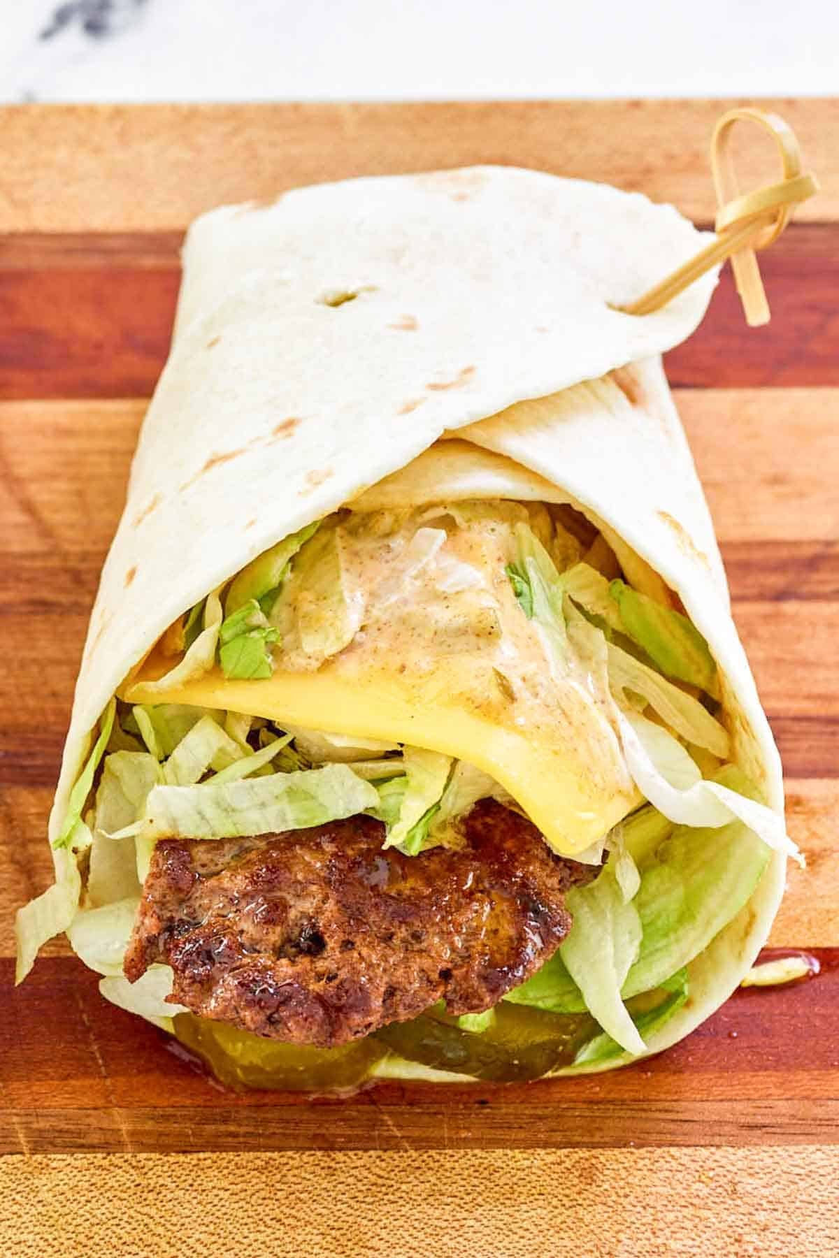 A cheeseburger wrap with special sauce.