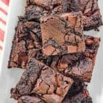 Chocolate chunk fudgy brownies on a platter.