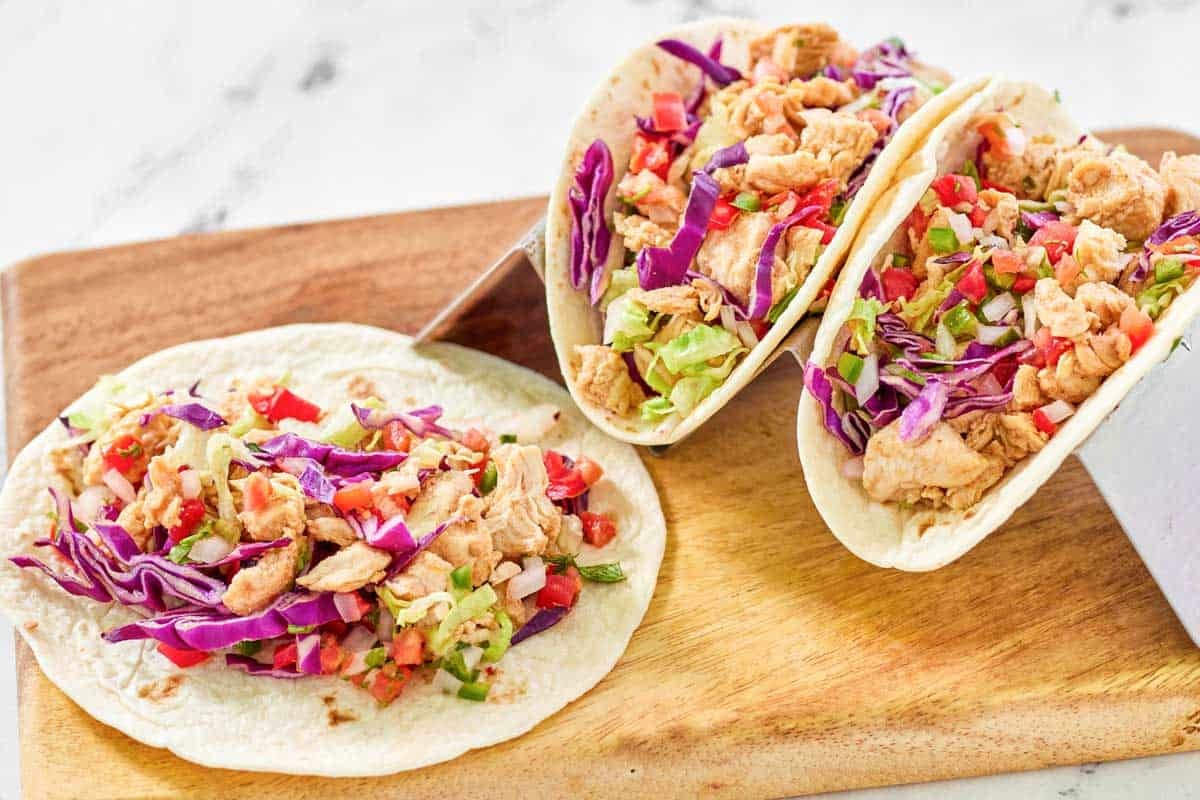 Flour tortilla chicken tacos with fresh toppings and pico de gallo.