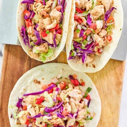 Flour tortilla chicken tacos with pico de gallo and fresh toppings.