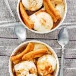 Copycat Brennan's bananas foster in two bowls and two spoons by them.