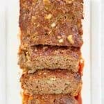 Brown sugar meatloaf with slices cut and on a long platter.
