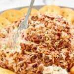 Pecan coated deviled ham cheese ball served with crackers.