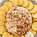 Deviled ham cheese ball surrounded with crackers on a platter.