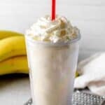 Copycat Fatburger banana milkshake and bananas behind it.