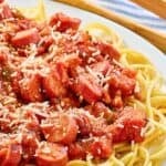 Spaghetti noodles topped with hot dog tomato sauce.