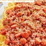 Hot dog spaghetti topped with grated Parmesan cheese.