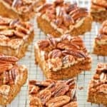 Homemade pecan pie brownies on top of a wire rack.