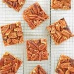 Pecan pie brownies scattered on a wire rack.