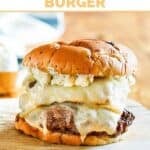 Copycat Smashburger French onion burger on a wooden cutting board.