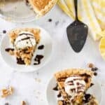 Two slices of classic Toll House pie served with ice cream and chocolate syrup on top.