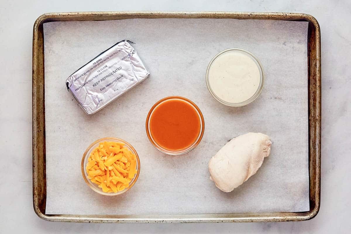 Cooked chicken, cheddar cheese, cream cheese, Buffalo sauce, and ranch dressing.