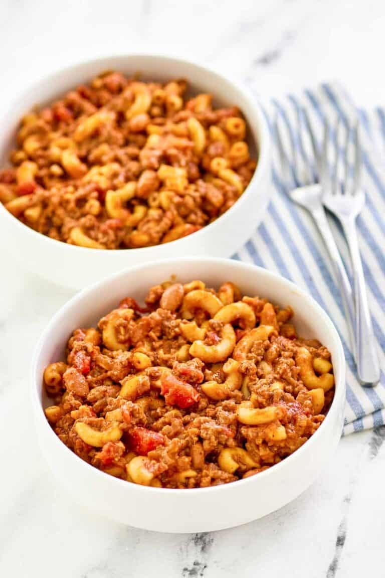 Macaroni with chili and cheese served in bowls.