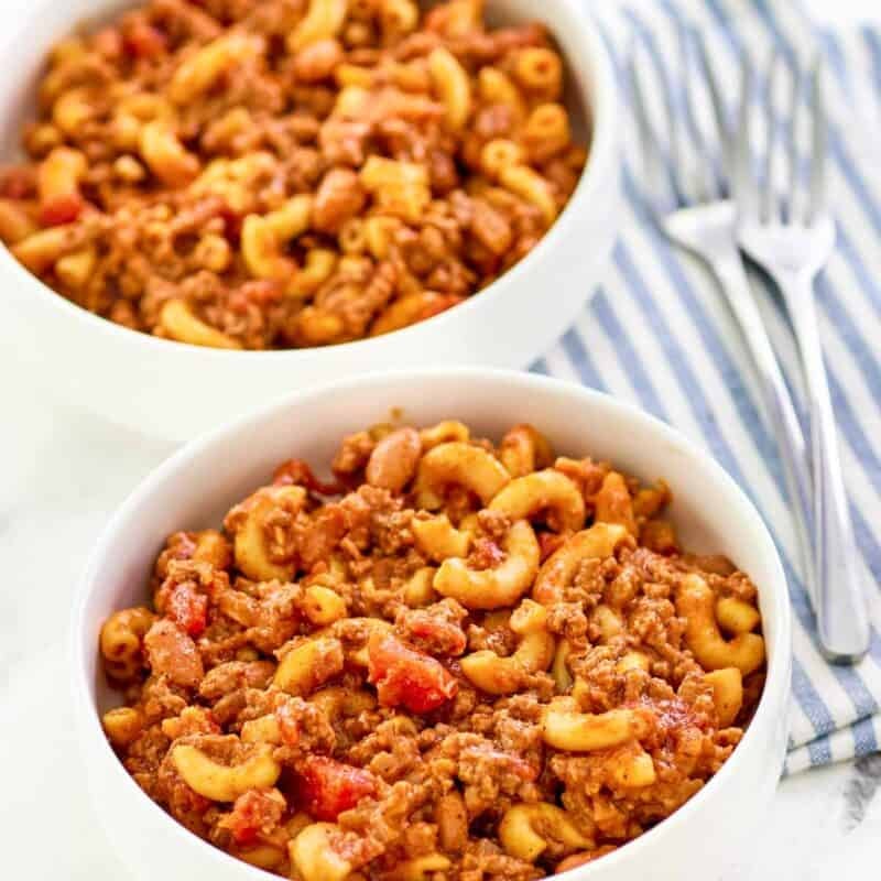 Macaroni with chili and cheese served in bowls.