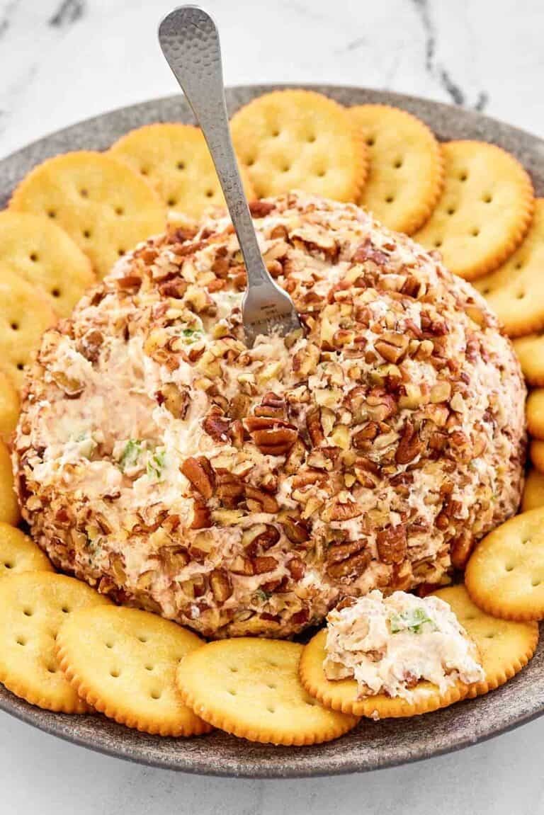 Pecan coated deviled ham cream cheese ball with crackers.