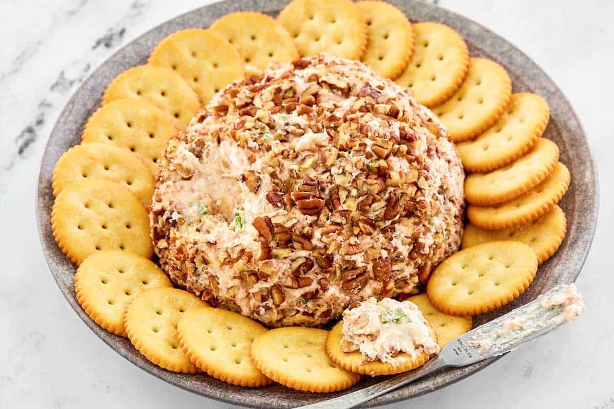 Pecan coated ham cheeseball served with crackers.