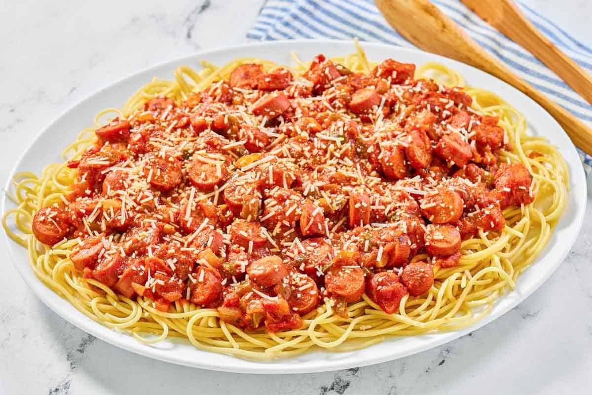 Spaghetti with hot dogs on a platter.