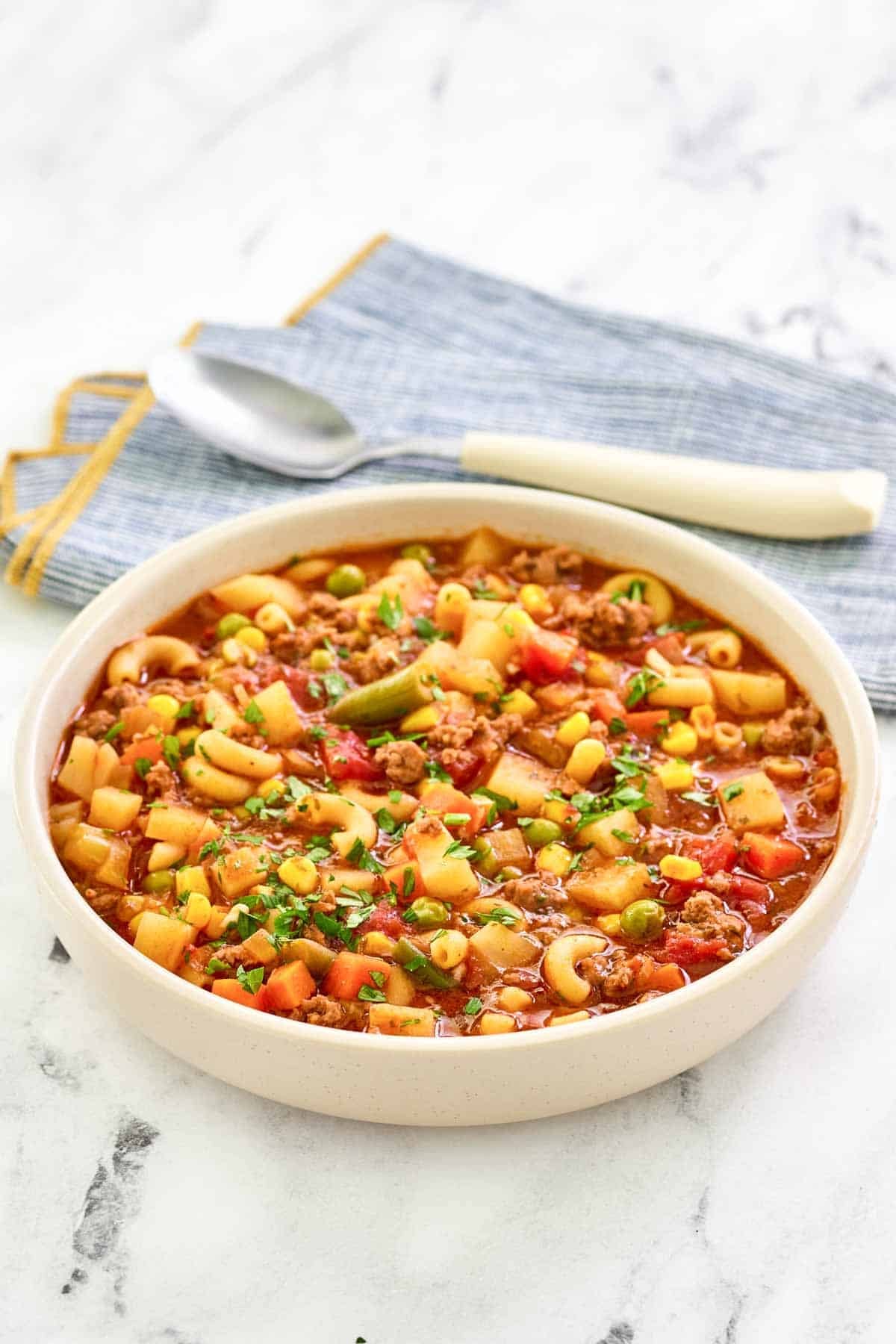 Tomato, ground beef, pasta, potato, and vegetable soup.