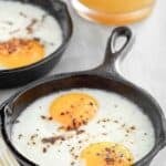 Oven baked eggs in a small cast iron skillet.