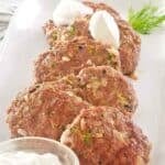 Healthy homemade chicken croquettes and creamy sauce on a platter.