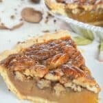 A slice of copycat Dear Abby pecan pie on a dessert plate.