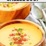 Copycat Houston's Canadian cheese soup topped with chopped parsley and red pepper.