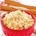 A bowl of copycat KFC coleslaw on a marble surface.