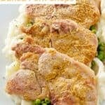 A platter of baked mustard crusted pork chops, mashed potatoes, and peas.
