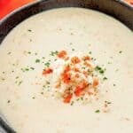 Homemade Charleston she crab soup in a bowl garnished with crabmeat, crab roe, and parsley.
