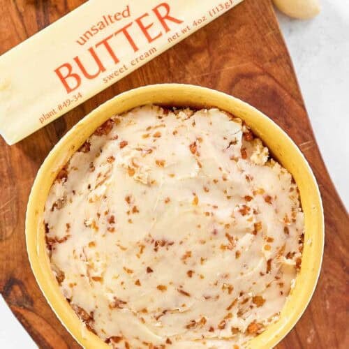 Japanese garlic butter in a bowl, a stick of butter, and garlic cloves.
