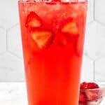 Refreshing watermelon strawberry lemonade drink in a tall glass.